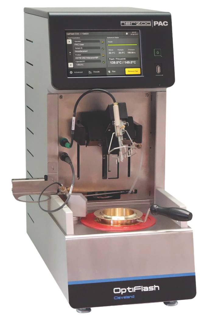 Laboratory device called OptiFlash with a digital screen displaying settings, metallic base, and testing compartment. Modern, precise, technical tool. OptiFlash Cleveland Open Cup.
