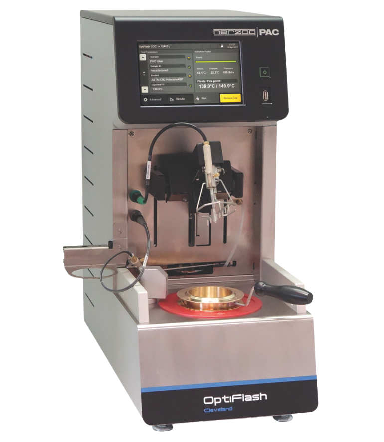 Laboratory device called OptiFlash with a digital screen displaying settings, metallic base, and testing compartment. Modern, precise, technical tool. OptiFlash Cleveland Open Cup.