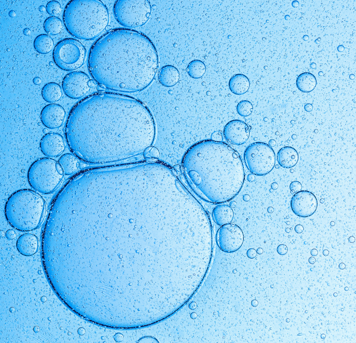 Blue background with various sized transparent bubbles, interconnected, creating a calming, fluid pattern. The image evokes a sense of serenity.
