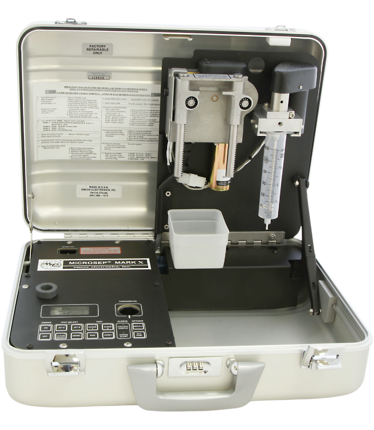 Open portable micro-separometer from Emcee with a digital display and keypad on the left, sample chamber and tubing on the right, set against a transparent background.