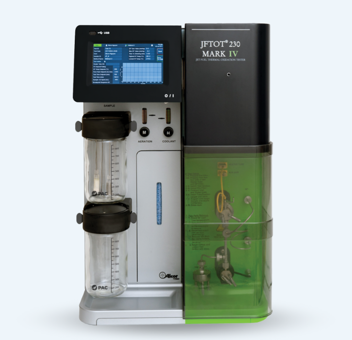 JFTOT 230 Mark IV jet fuel tester with a digital display showing data and graphs. Two sample containers and tubes visible. Clean, technical design.