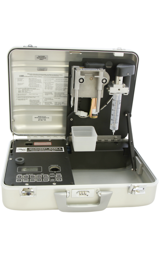 Open portable micro-separometer from Emcee with a digital display and keypad on the left, sample chamber and tubing on the right, set against a transparent background.