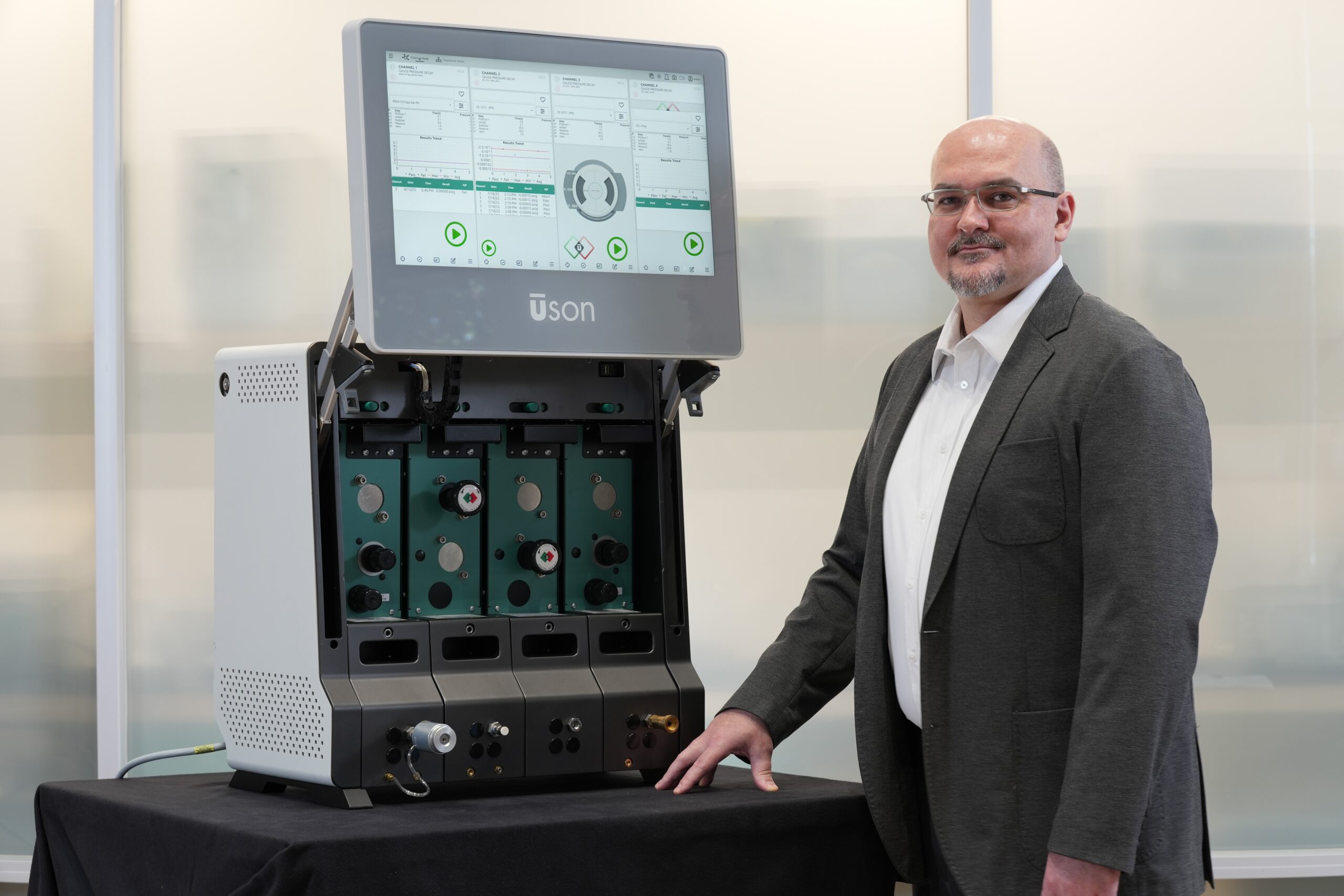 Meet a man standing beside a large laboratory Astra Dash device with a large display screen.