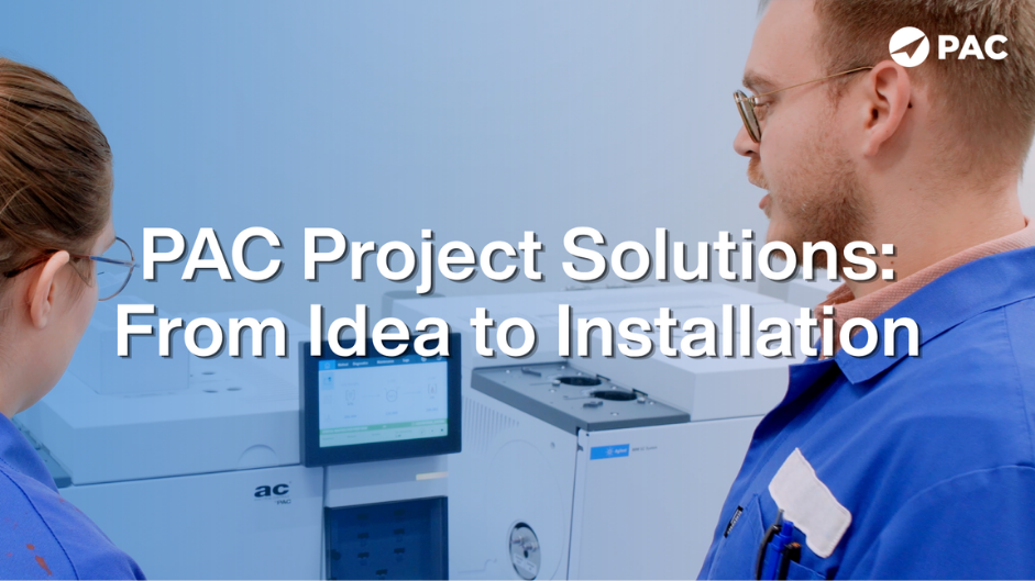 Two professionals in blue lab coats discuss equipment in a lab setting, with text overlay: 