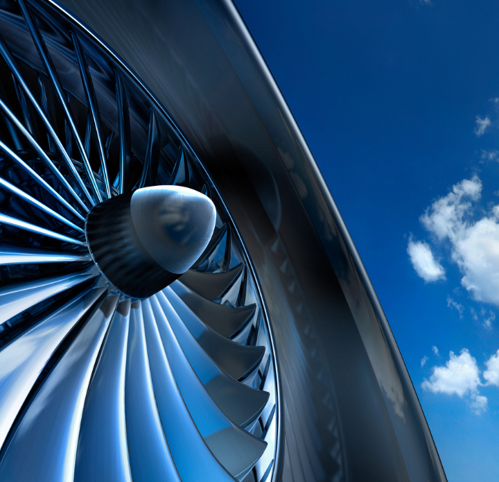 Jet engine against a clear blue sky, showcasing its sleek design and powerful structure.