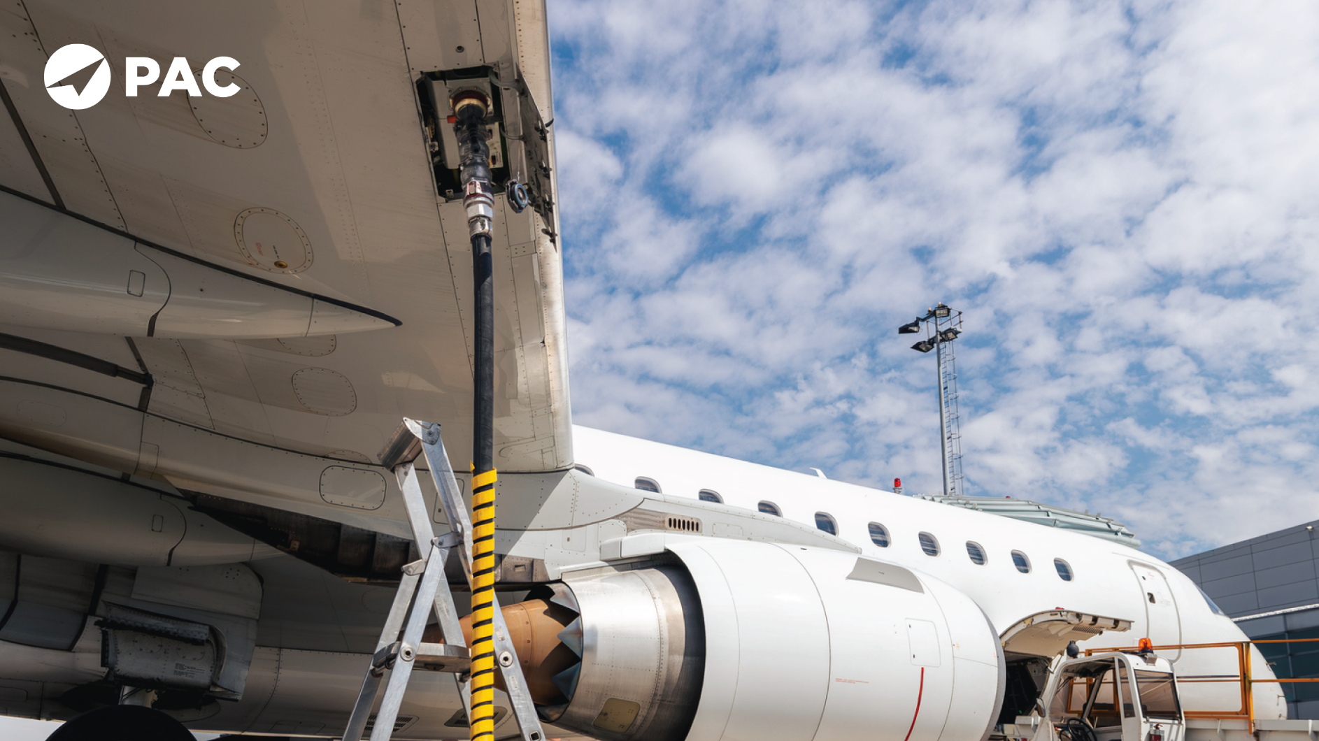 A white airplane with a yellow hose connected, likely for refueling or maintenance purposes. D8073 Concerns.